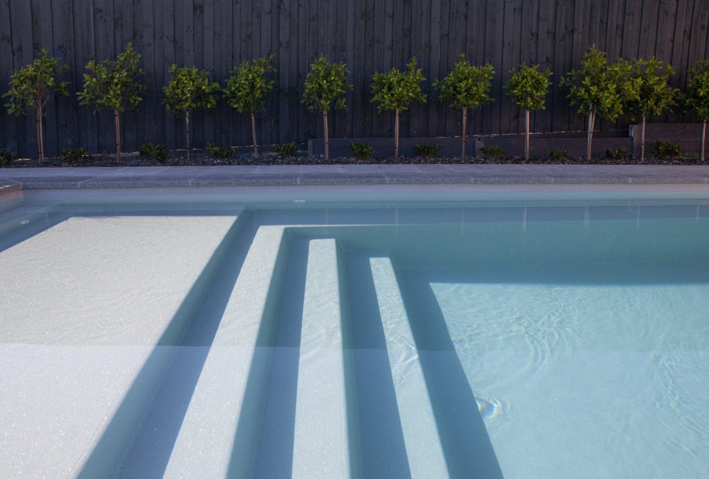 Fibreglass pool entry steps and swim-out shelf installed by Master Pools, South East Melbourne