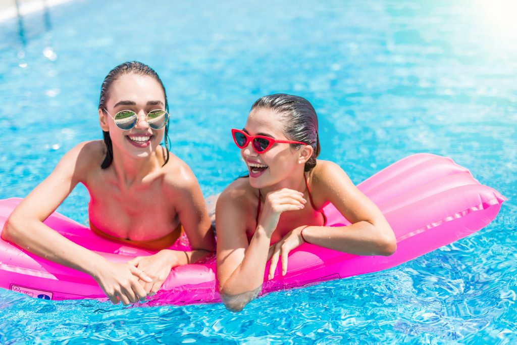 Melbourne teenagers swimming and relaxing by a backyard fibreglass pool, representing family connection and the teen trap concept for keeping kids at home.