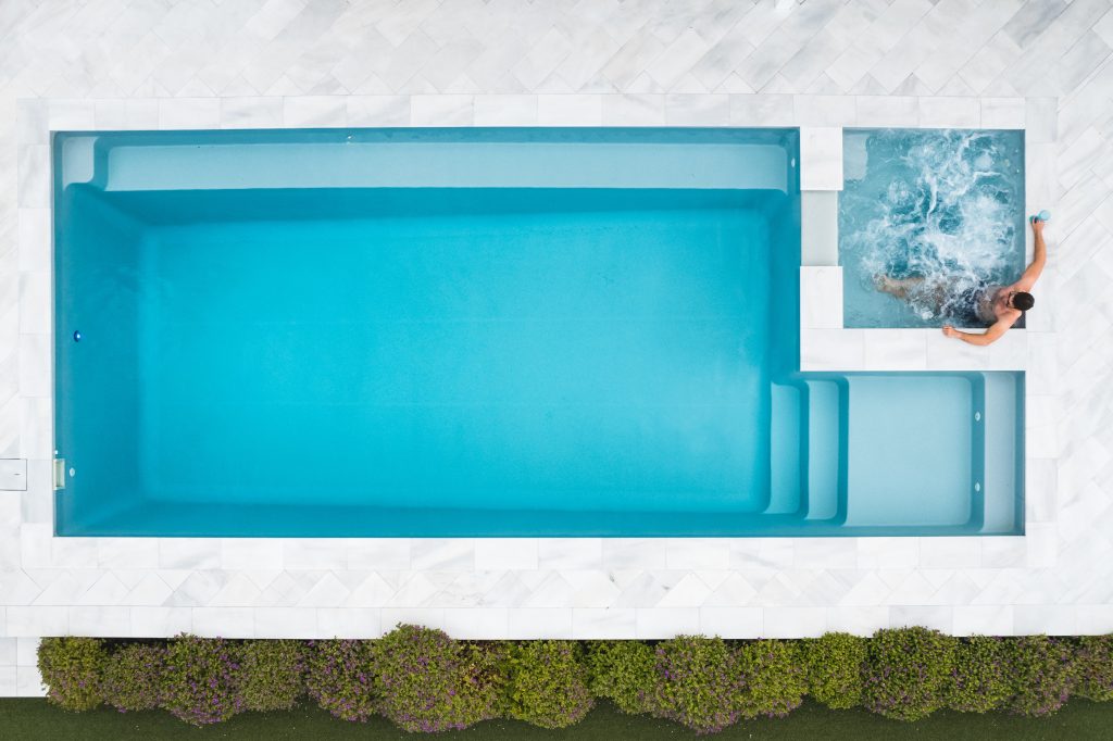 Aerial view of the Saint Louis fibreglass pool and spa combo in Platinum colour, with wide entry steps and bubbling spa, installed by Master Pools Melbourne